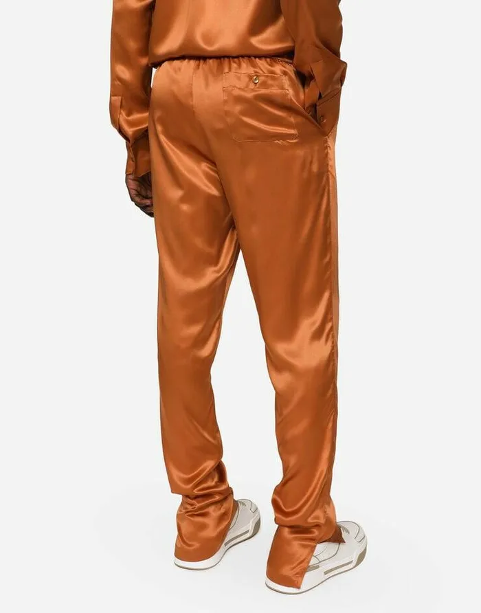 Dolce and Gabbana Trousers And Shorts Men Silk Satin Jogging Pants With Metal DG Logo Beige Dolce and Gabbana Trousers And Shorts Men Silk Satin Jogging Pants With Metal DG Logo Beige