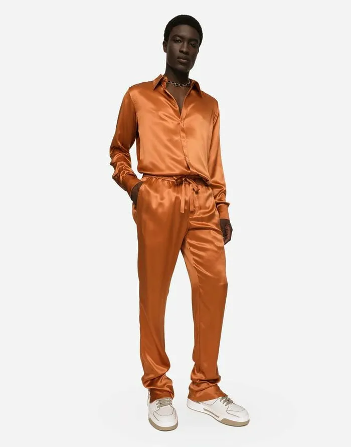 Dolce and Gabbana Trousers And Shorts Men Silk Satin Jogging Pants With Metal DG Logo Beige Dolce and Gabbana Trousers And Shorts Men Silk Satin Jogging Pants With Metal DG Logo Beige